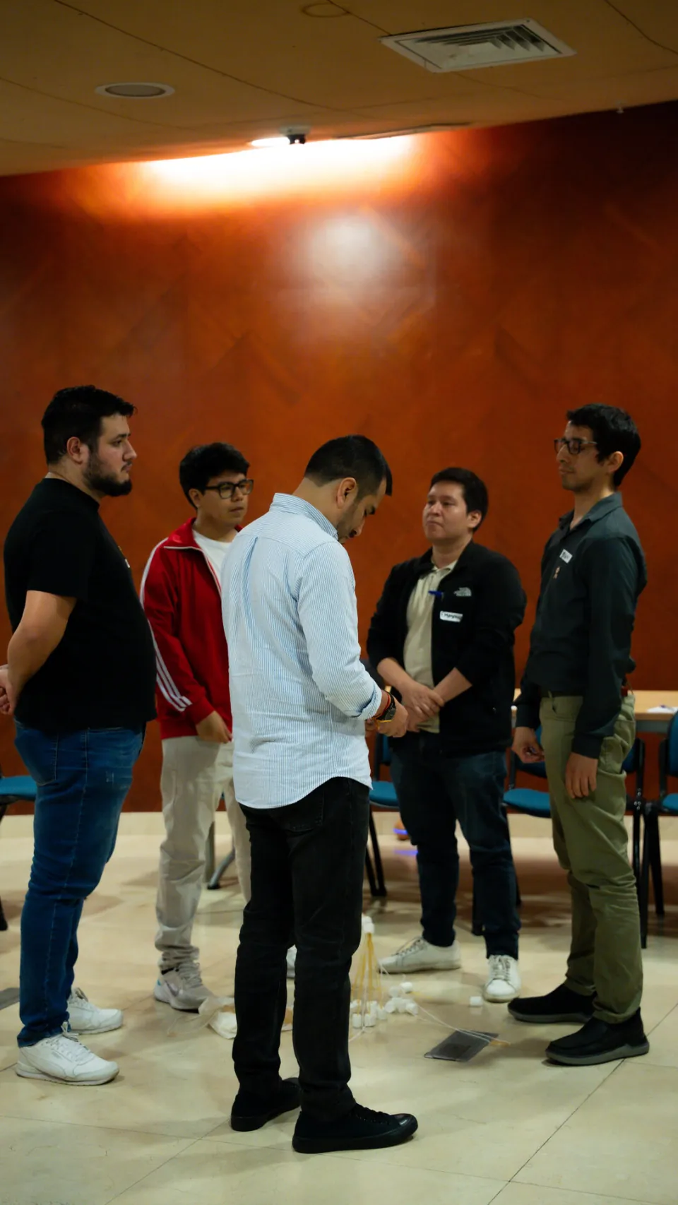 Grupo de participantes conversando de pie en círculo pequeño durante el taller Ágil de Verdad Edición 01